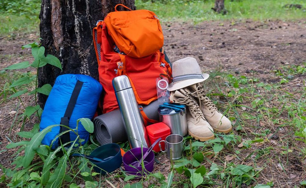 Backpack, thermos, sleeping bag, compass, hat and shoes